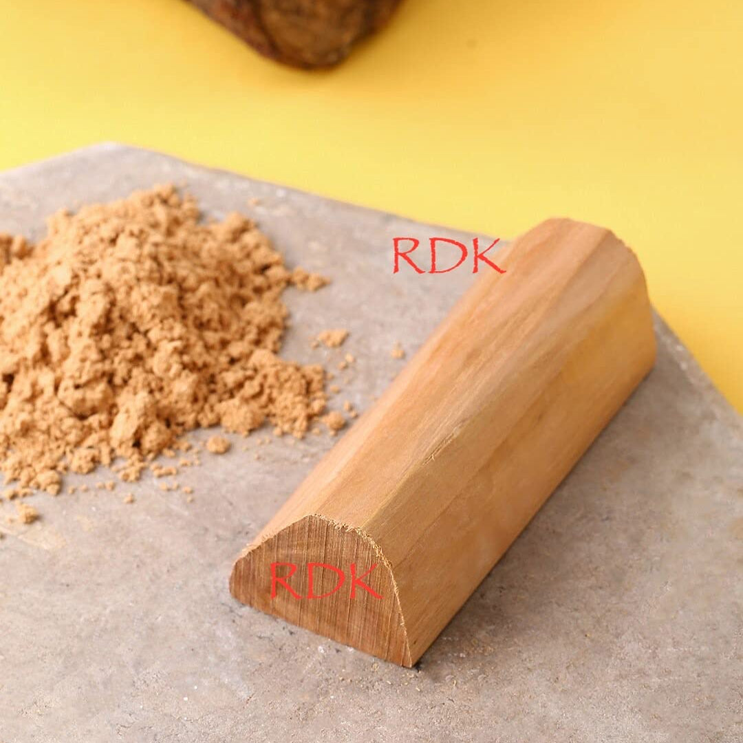 Wooden rolling pin with 'RDK' branding on a yellow background